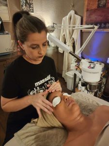 Kathleen giving a client a relaxing facial at Fancy's Day Spa.
